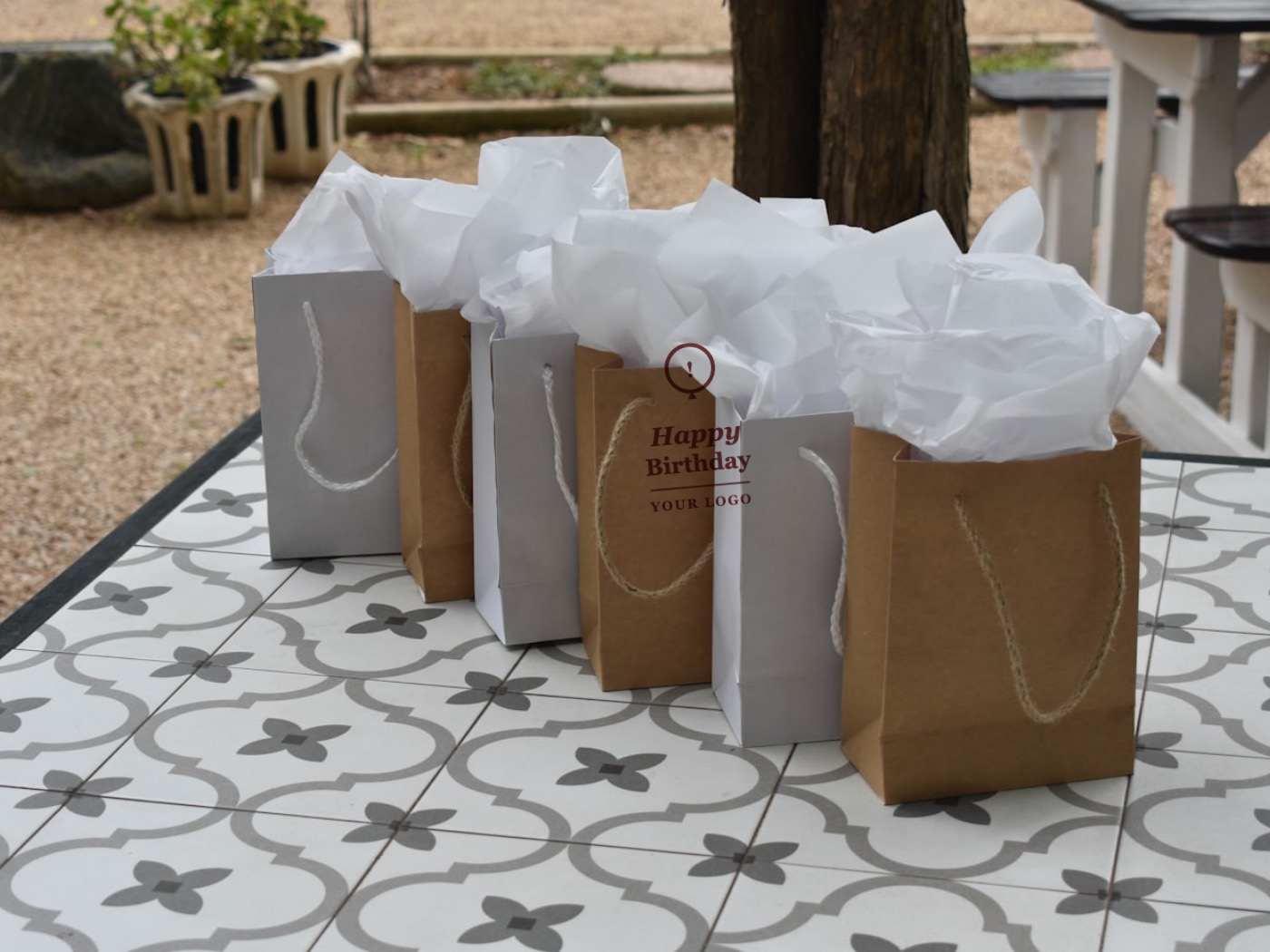 Gift bags with a printed Happy Birthday YOUR LOGO sample design